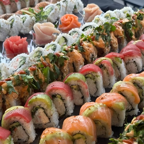 A vibrant platter showcases an array of sushi rolls, including salmon, tuna, and avocado.